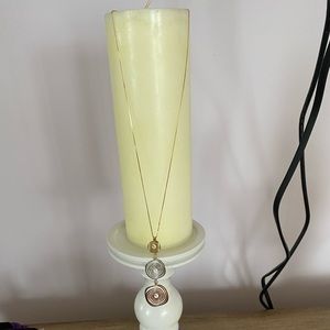 14k yellow gold chain with a tri-gold pendant.